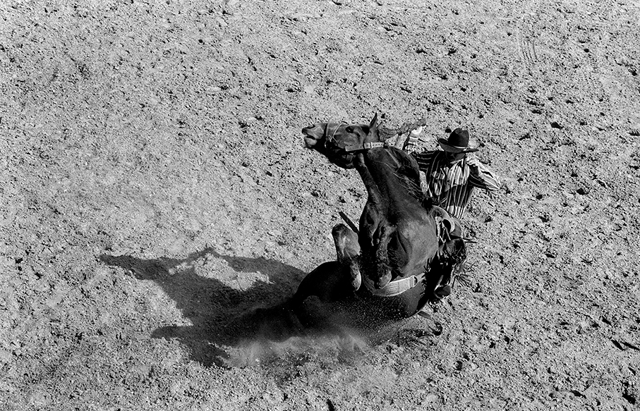 black and white image of man horseback riding
