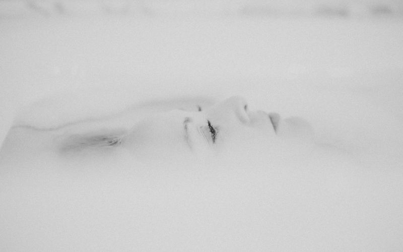B&W image of a girl's face in snow