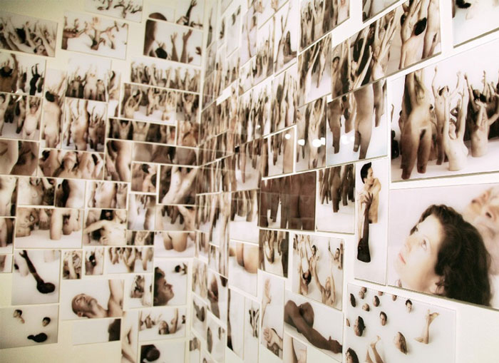 An image of nude photographs stuck all over the wall