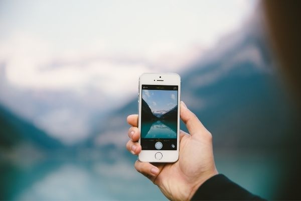 man capturing pictures with a smartphone