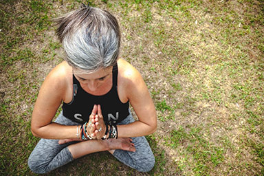 Lady doing yoga with folded hands pose