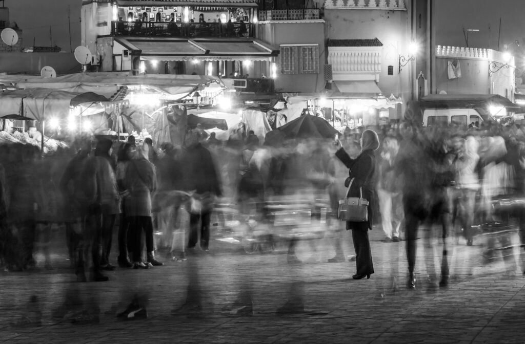 a black and white long exposure cityscape of a crowded street