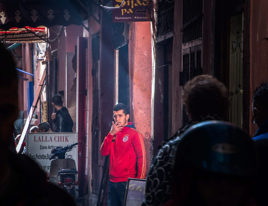 Hispanic man smoking cigarette on the streets