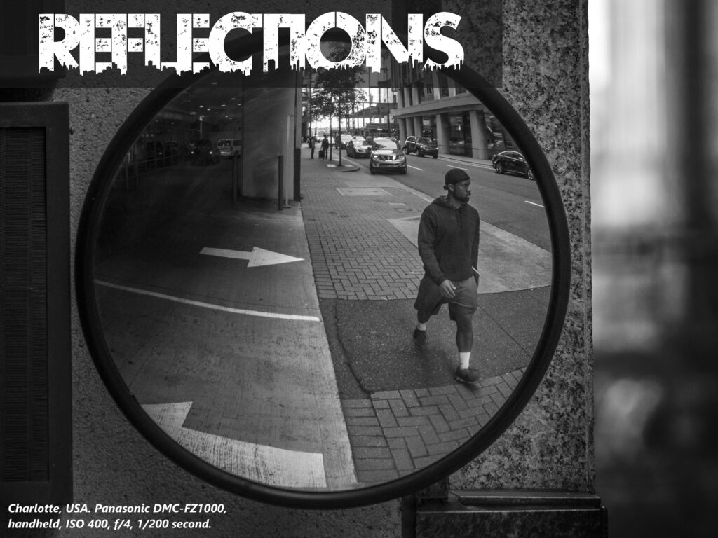 reflection of a black man walking bw image reflections cover