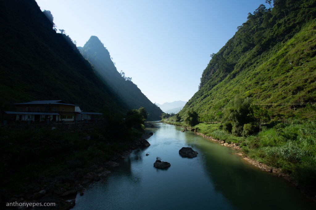landscape of river flowing between green mountains