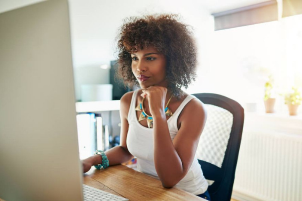 black woman with afro working on a desktop