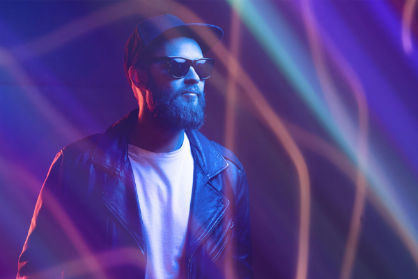 bearded guy with cap and glasses with neon trails overlay applied