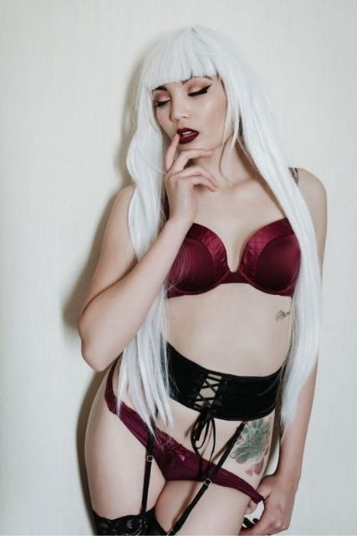 model with white hair wearing raunchy corset