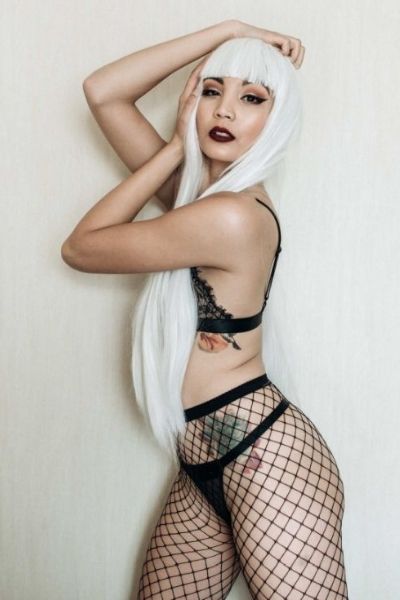 model with white hair posing in sexy black lingerie