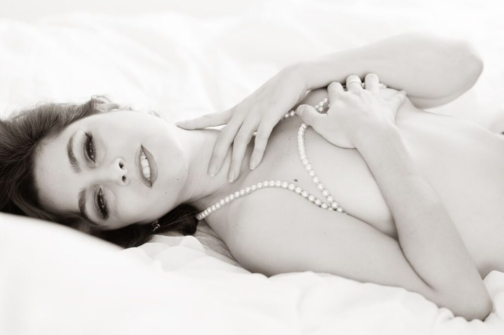bw image of topless female model lying down