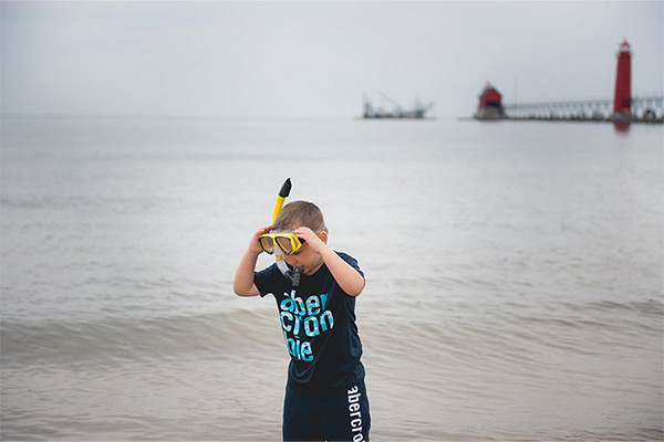 Boy holding a diver goggles