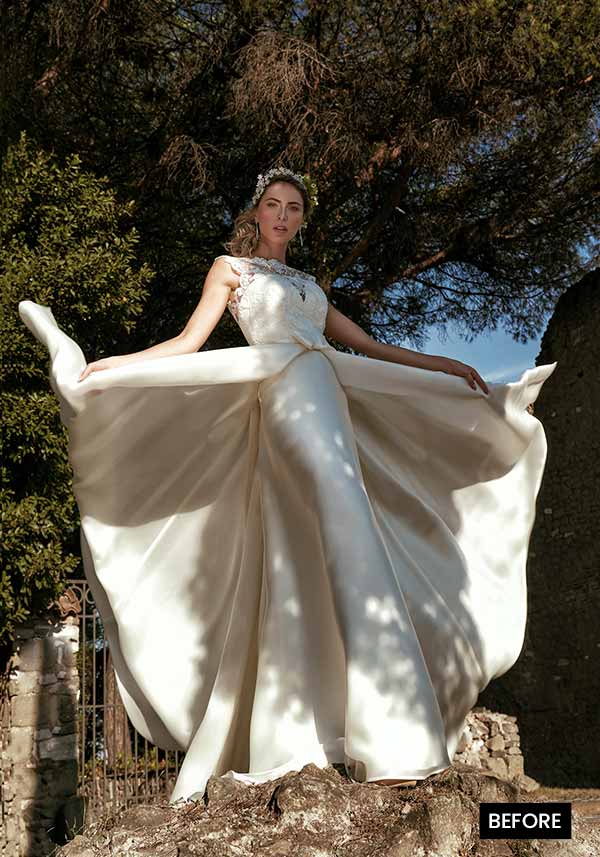 A bridal model posing with her flaired gown before preview