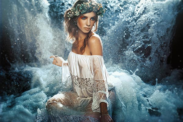Advanced photo compositing image of a model sitting in a waterfall