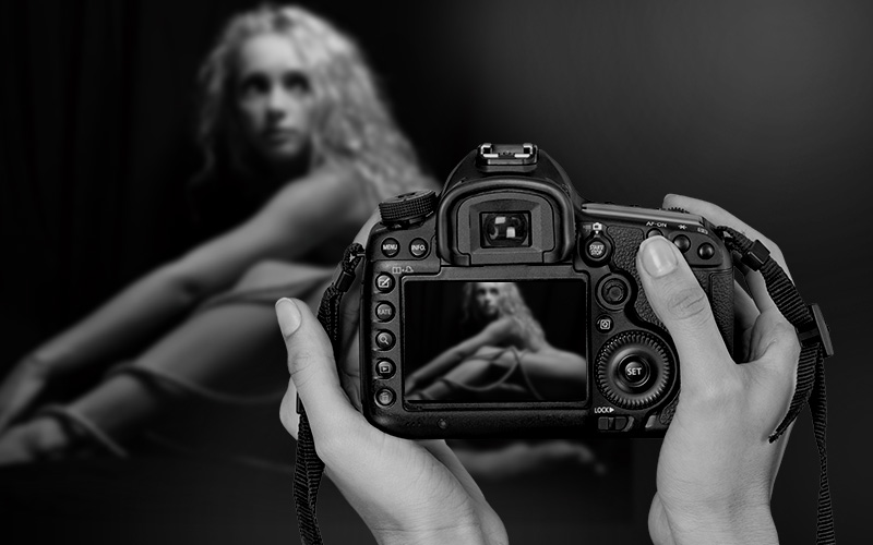 Nude Photographer capturing a nude model in camera