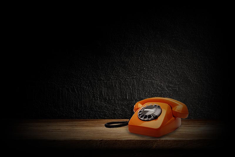 Composite of a telephone with a dark background
