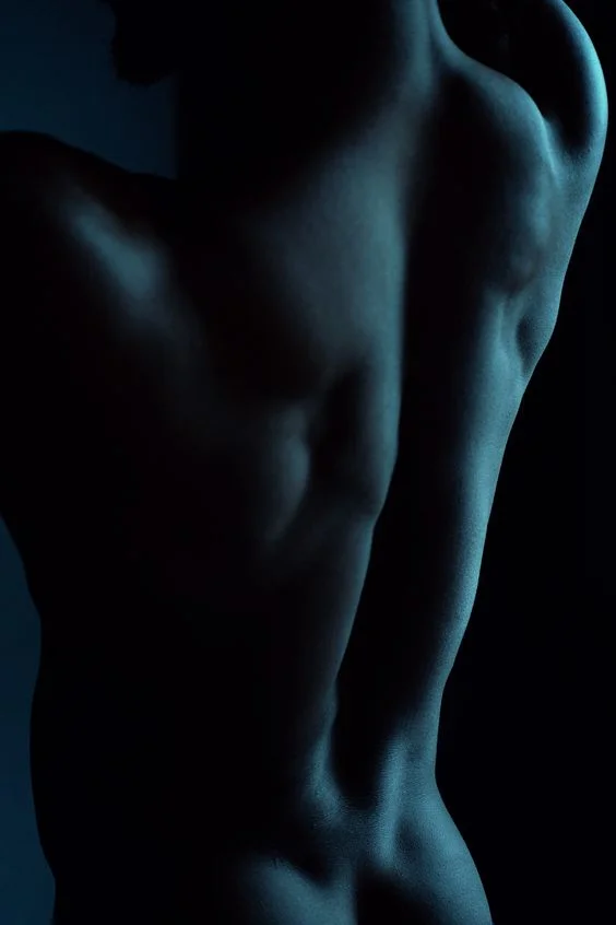 blue light focus on male boudoir model