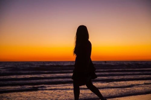 standing woman sunset silhouette