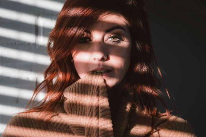 windows grills shadow on face pose for woman