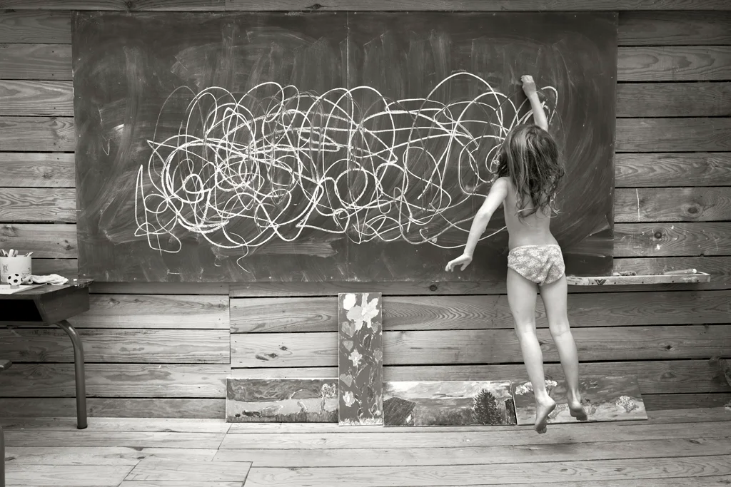 A girl drawing on the board