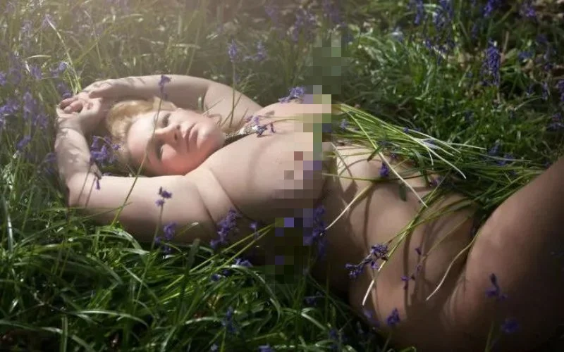 Curvy model nude in the grass