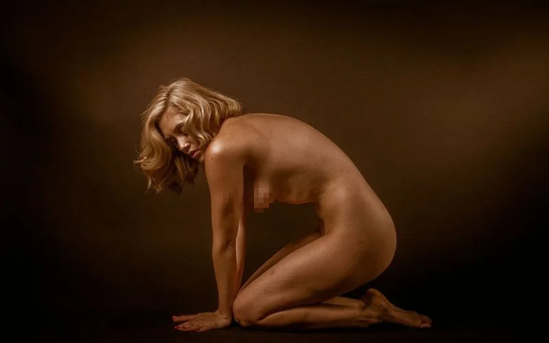 side shot of a fully nude blonde model