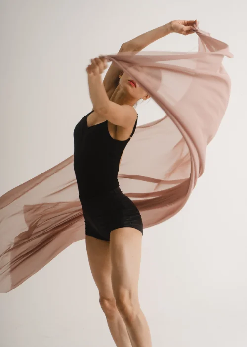 a lady dancing with a fabric
