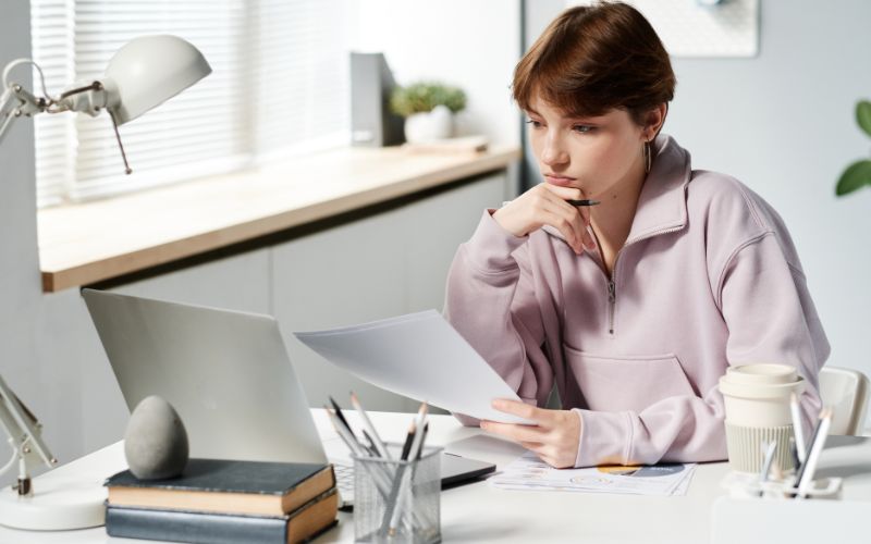 Girl in hoodie analyzing budget