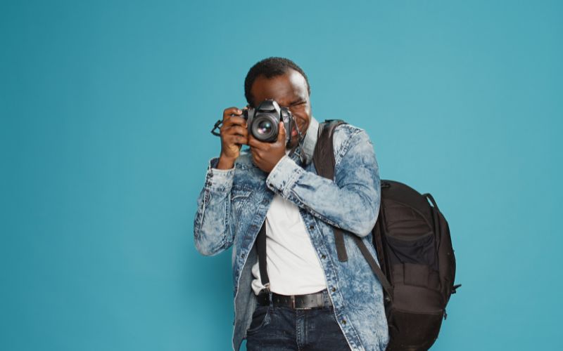 a man holding a camera and taking picture