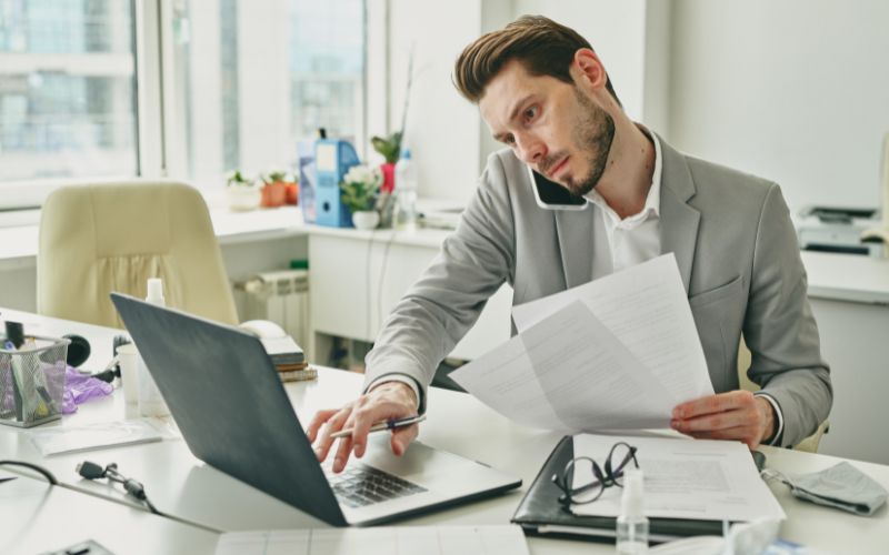 Busy young office worker in formalwear consulting client