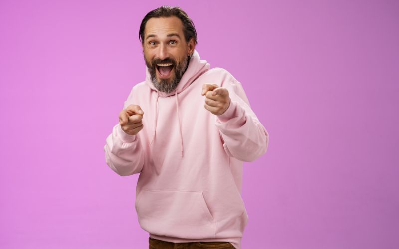 Gotcha. Portrait carefree funny amusing adult energized bearded man jumping pranking friend