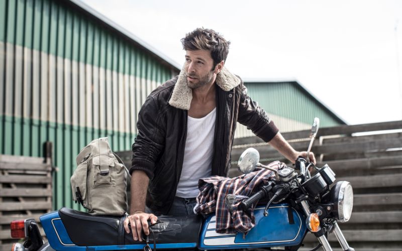 a man with a bike posing