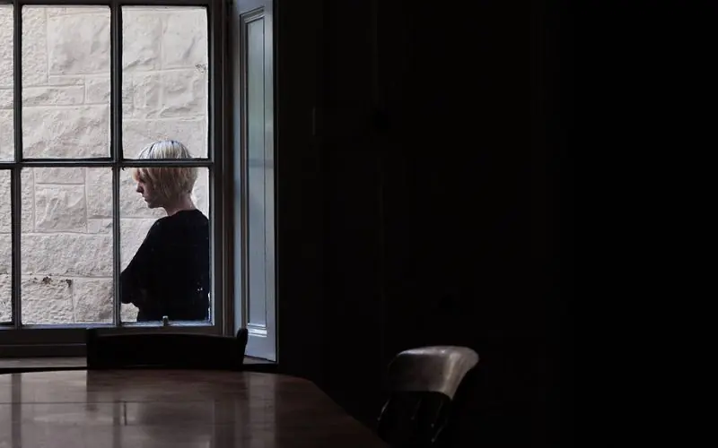 Lady standing outside window captured