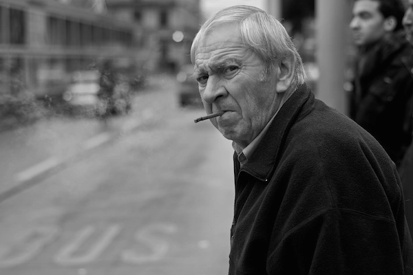 Man smoking cigar on streets