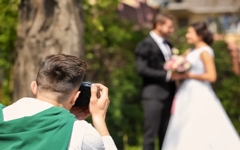 wedding photographer clicking pictures of bride and the groom
