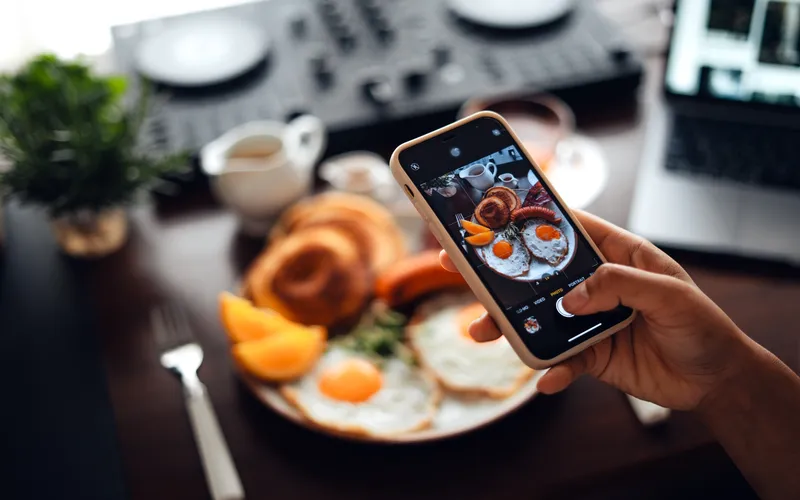 clicking pictures of breakfast with a smartphone for the photo blog