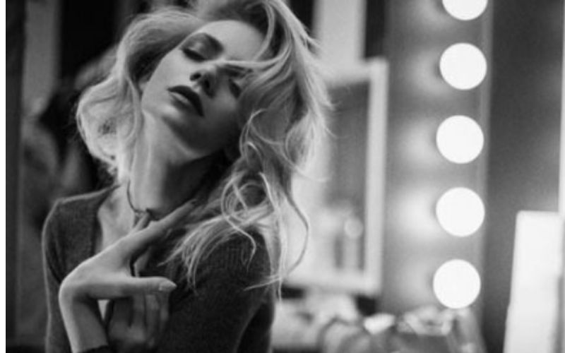 An image of a woman posing with her eyes closed