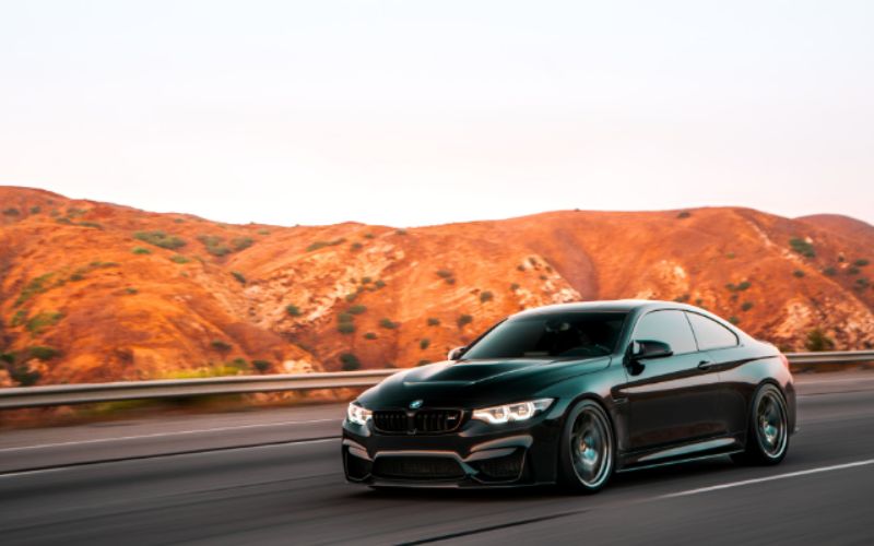 An image of a black BMW car on the road