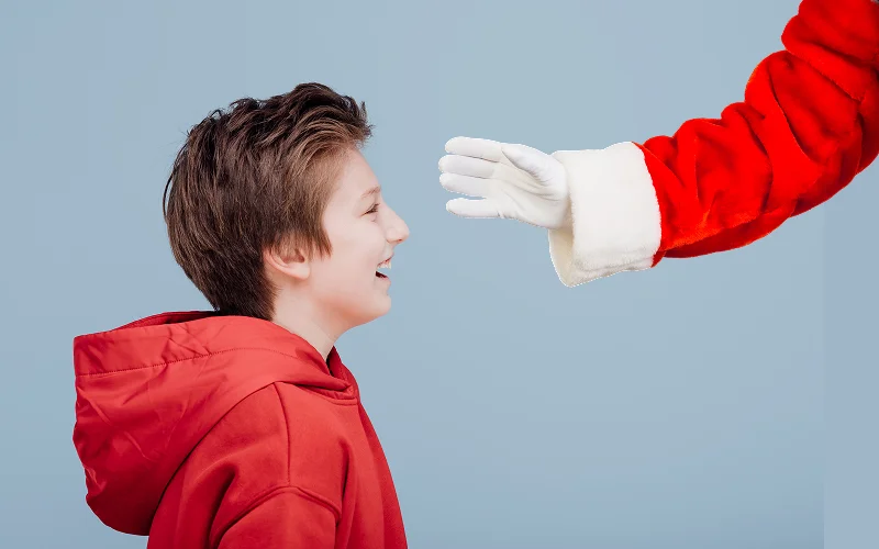 photo of a boy after editing with Santa hand overlays