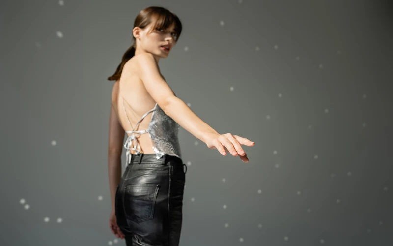 Woman in a metallic dress captured mid-movement, showing the expressive power of figure fine art photography