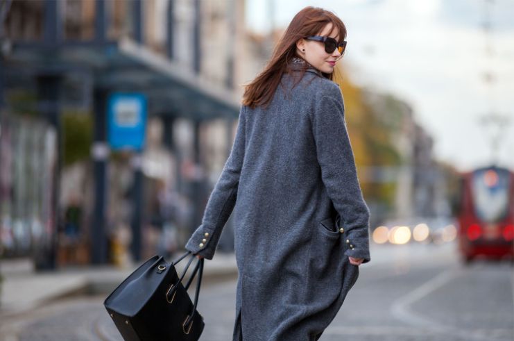 woman walking, looking over the shoulder wearing shades