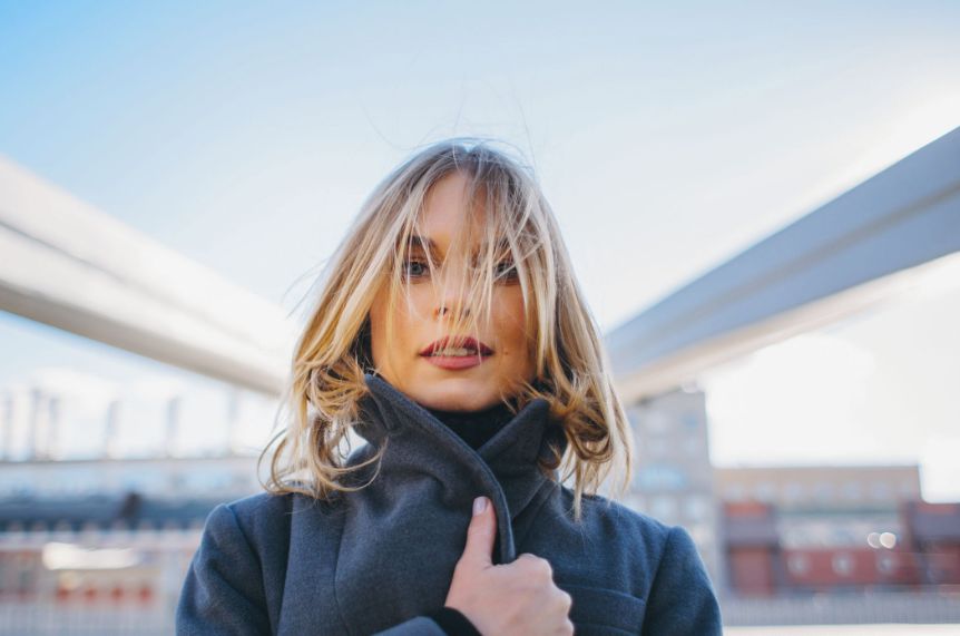 portrait of a woman wearing a dark green sweater with Polaroid 400 grading applied