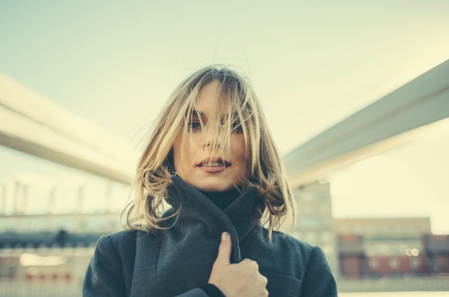 portrait of a woman wearing a dark green sweater with Polaroid 600 grading applied