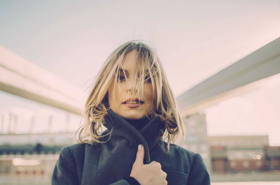 portrait of a woman wearing a dark green sweater with Polaroid SX 70 grading applied