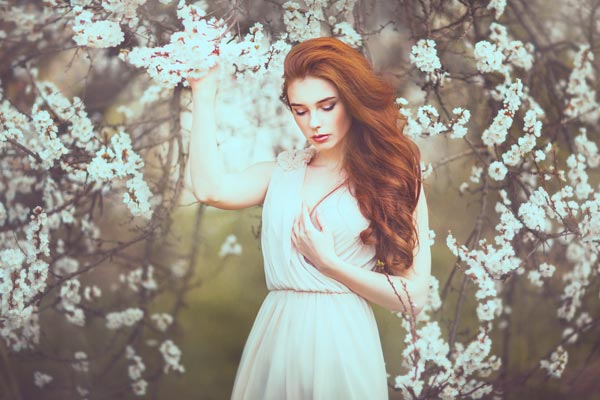 model wearing white holding white flowers with ps action applied