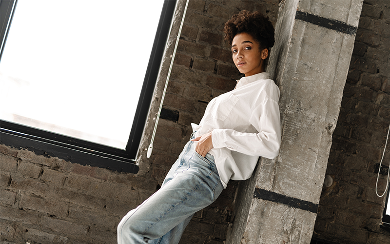 girl wearing white shirt leaning on wall