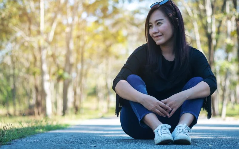 female sitting with relaxed fingers 