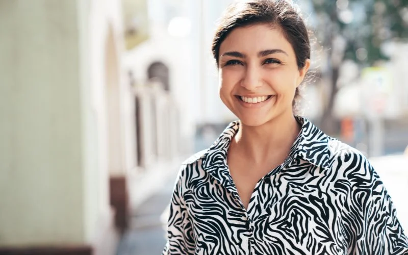 female model poses with an open smile