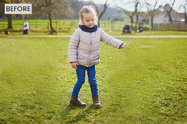A girl standing in a lawn