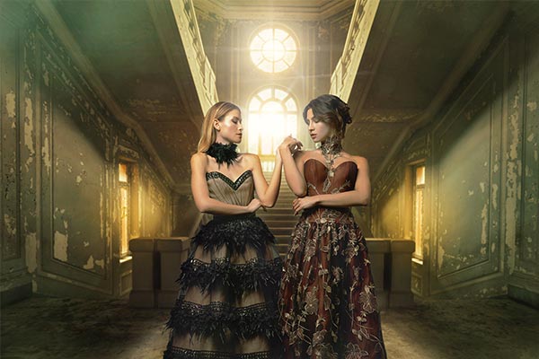 Two female models holding each others hand