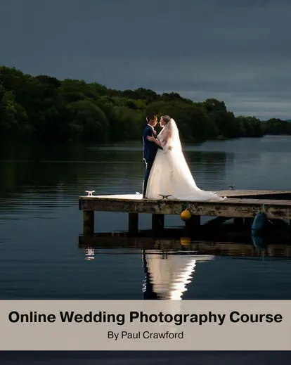 A beautiful wedding couple posing by the lake at night for wedding photoshoot